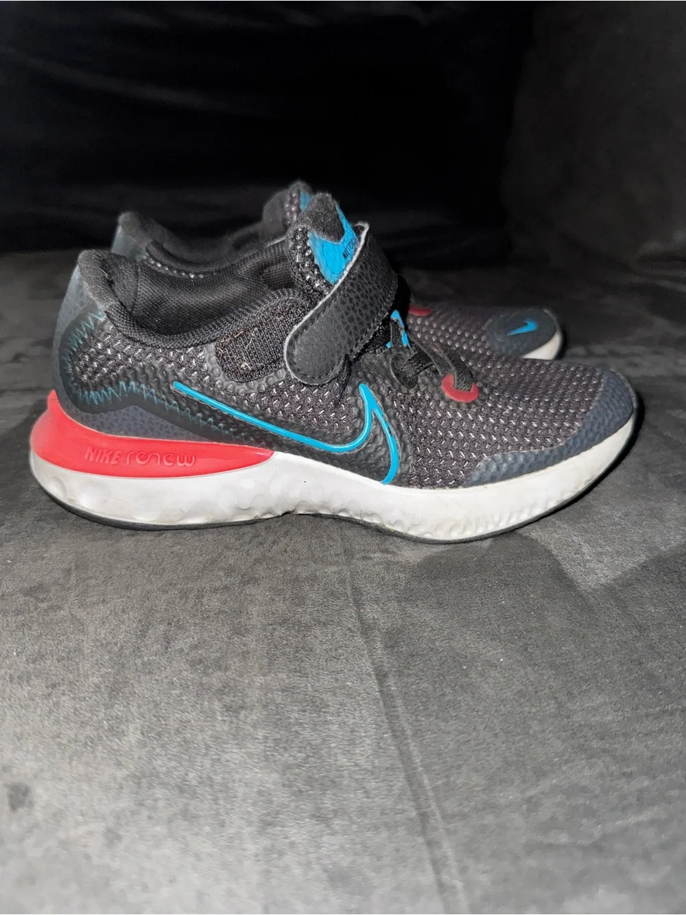 Renew Nike Kids size 13. Running Black Sneakers with Blue and neon pink .